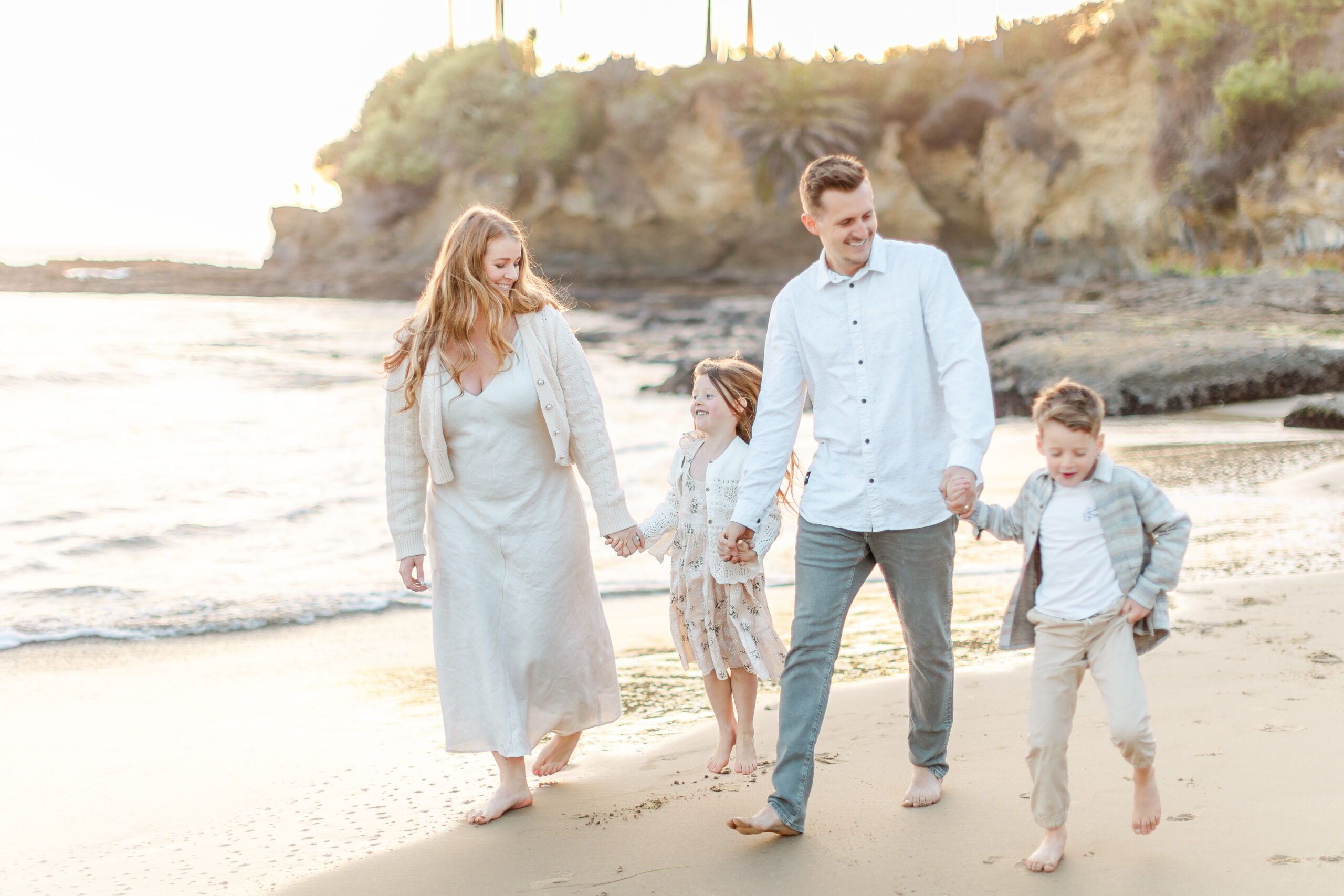 Family walking outdoors during a golden hour photo session in Orange County, California