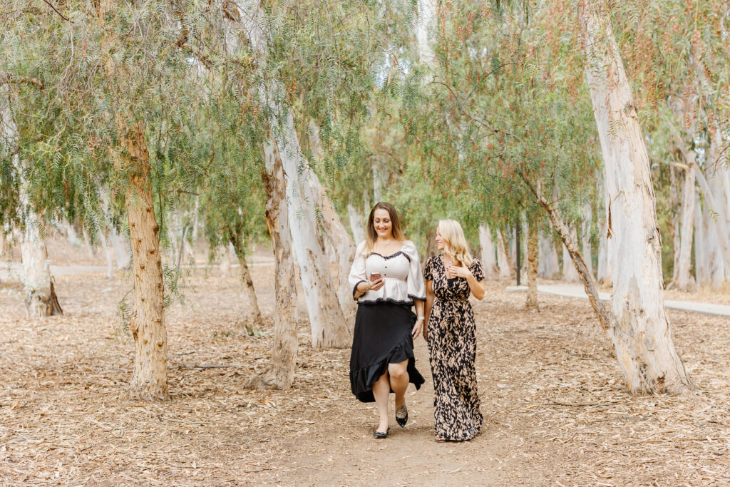 Women founders of The Million Dollar Room smiling during an outdoor branding session in Orange County, California